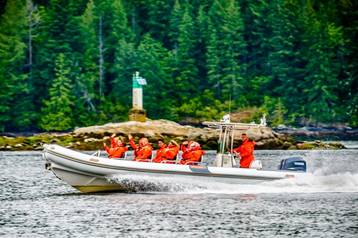 a group of people riding on the back of a boat