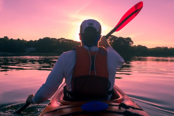 a person sitting in front of a body of water